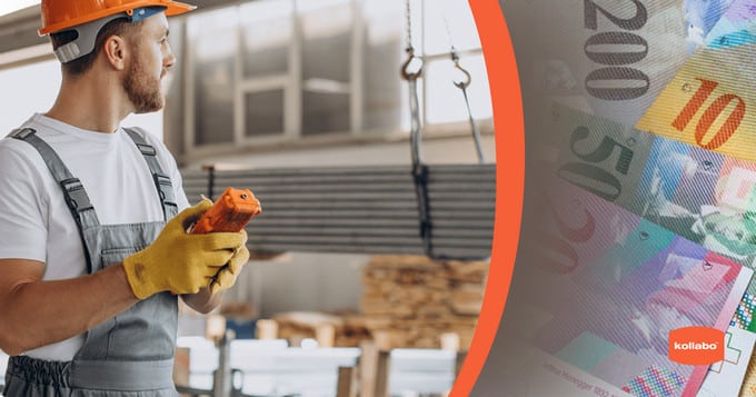 A man in a hard hat is holding money in front of a factory.