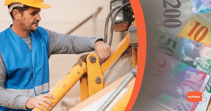 A man in a hard hat is working on a machine next to a pile of money.