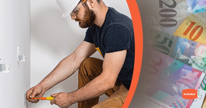 Ein Mann mit Schutzhelm arbeitet mit Geld an einer Wand.